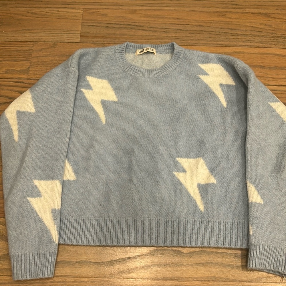 Light blue sweater with lightening detail